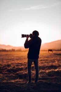Man shooting on camera beautiful African landscape